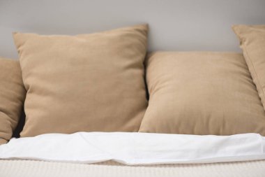 Close up of brown pillows on cozy empty bed  clipart