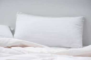 selective focus of bed with white pillow and blanket  clipart