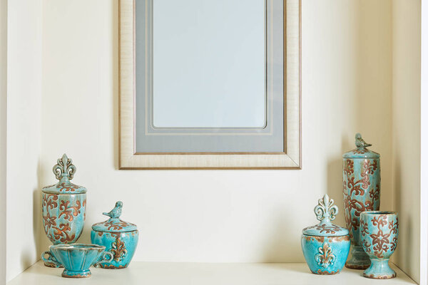  picture frame and turquoise set on shelf 