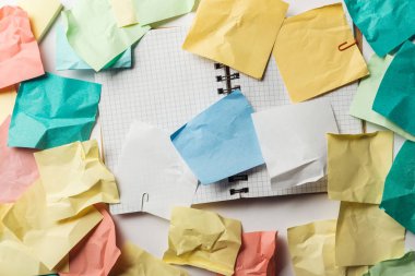 top view of opened notebook with squared papers near crumpled sticky notes  clipart