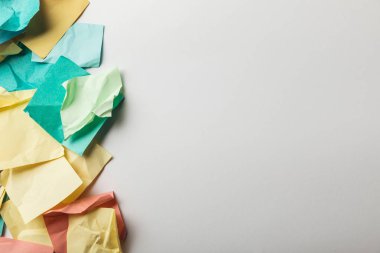 top view of crumpled colorful papers on white background clipart