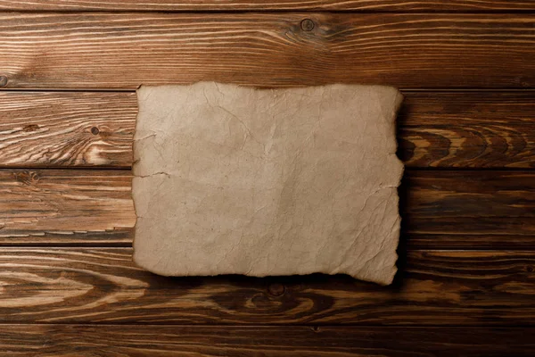 Hnědý Starý Pergamen Papír Ležící Dřevěné Pozadí — Stock fotografie