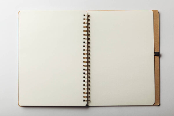 top view of opened notebook with blank pages on white background