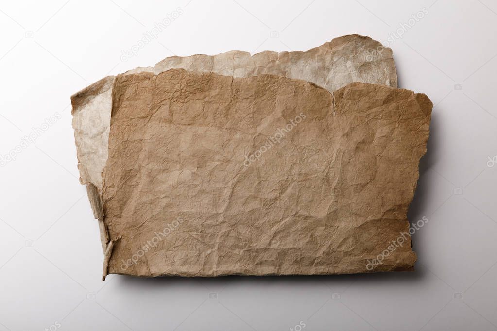 top view of aged paper sheets lying on white background 