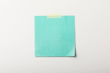 turquoise blank sticker with sticky tape on white background clipart