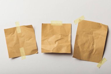 brown crumpled papers with sticky tape on white background clipart