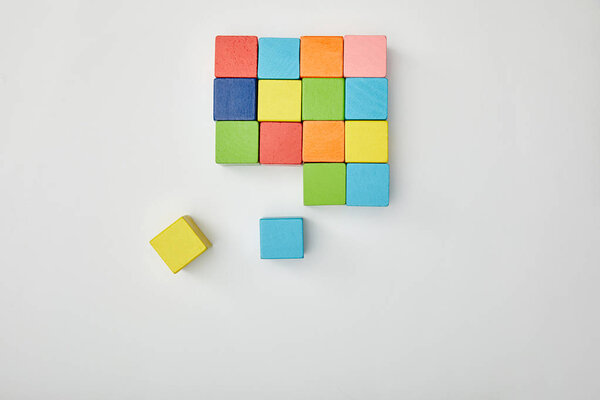 top view of multicolored blocks on grey background