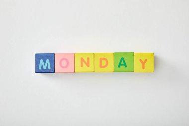 top view of monday lettering made of multicolored cubes on white background clipart