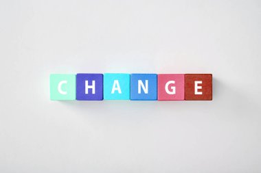 top view of change lettering made of multicolored cubes on grey background clipart