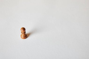wooden pawn piece of chess on grey background clipart