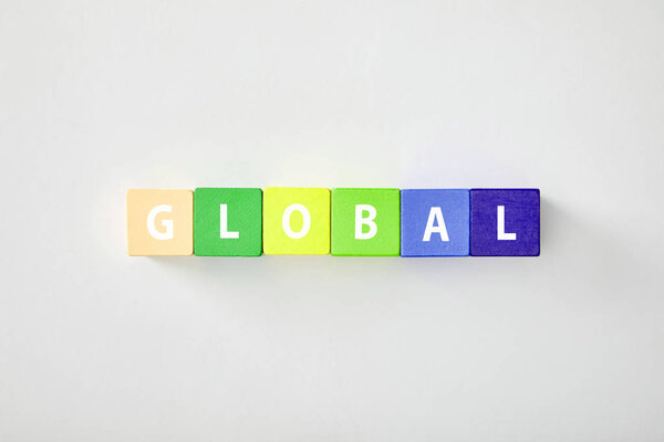 top view of global made of multicolored cubes on grey background