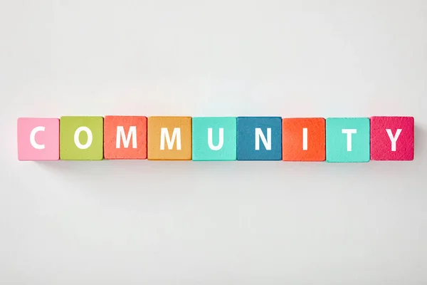 Top View Community Lettering Made Multicolored Cubes Grey Background — Stock Photo, Image