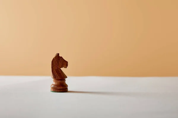 Wooden Knight Piece White Table Beige Background — Stock Photo, Image