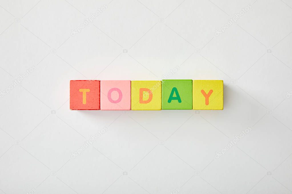 top view of today lettering made of multicolored cubes on white background