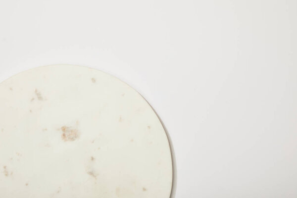 top view of empty marble round board on white background