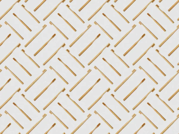 bamboo toothbrushes in different directions on grey background, seamless background pattern