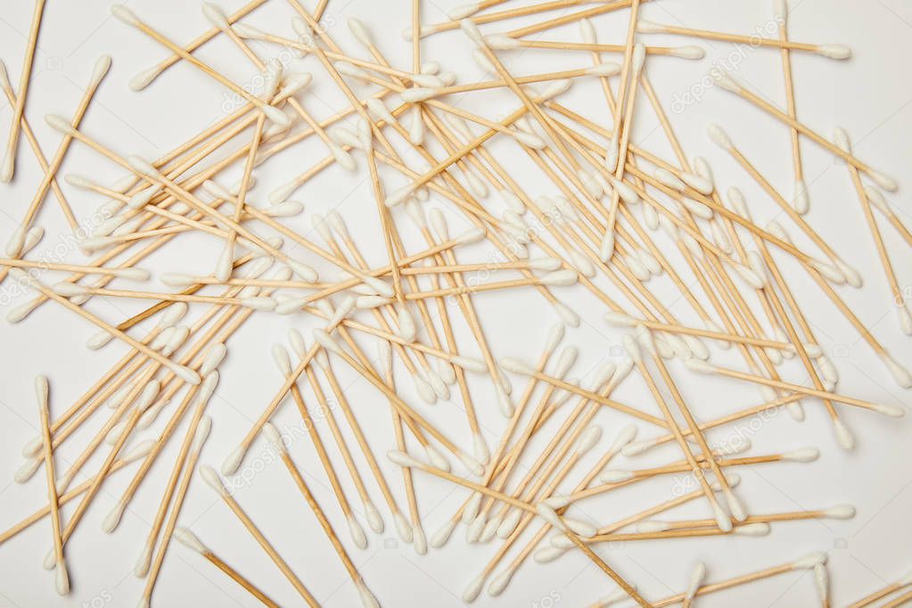 top view of ear sticks scattered on white background