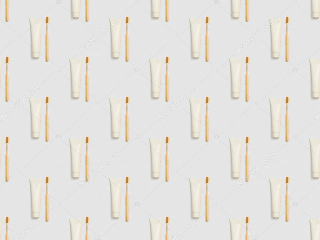 vertically located bamboo toothbrushes and toothpaste in tubes on grey background, seamless background pattern
