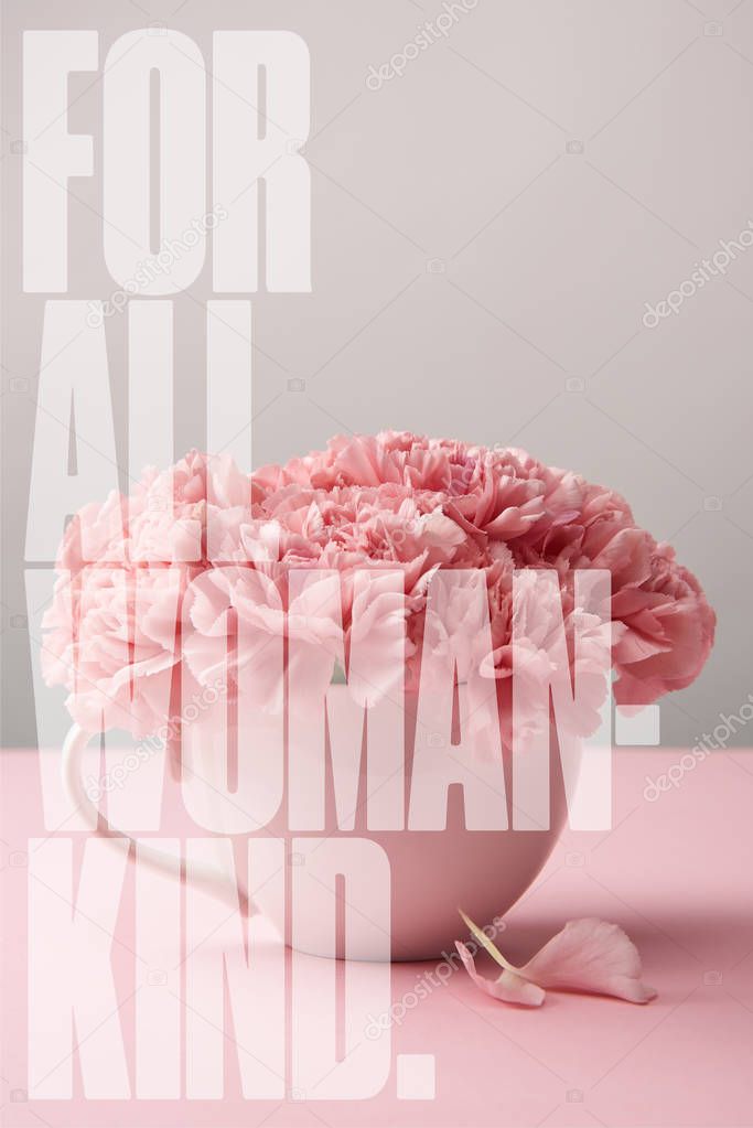 pink carnation flowers in cup on grey background with for all woman kind lettering