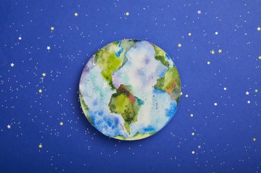 top view of planet picture on violet background with stars, earth day concept clipart