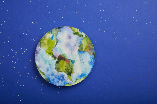 top view of planet picture on violet background with stars, earth day concept