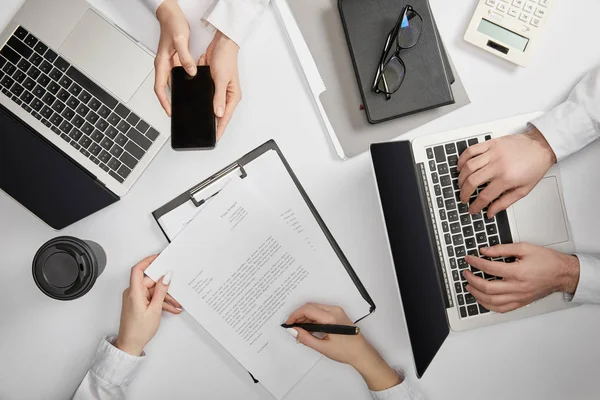 Top View Businesspeople Typing Laptop Holding Smartphone Signing Document — Stock Photo, Image