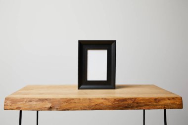 black square frame on wooden table at home clipart