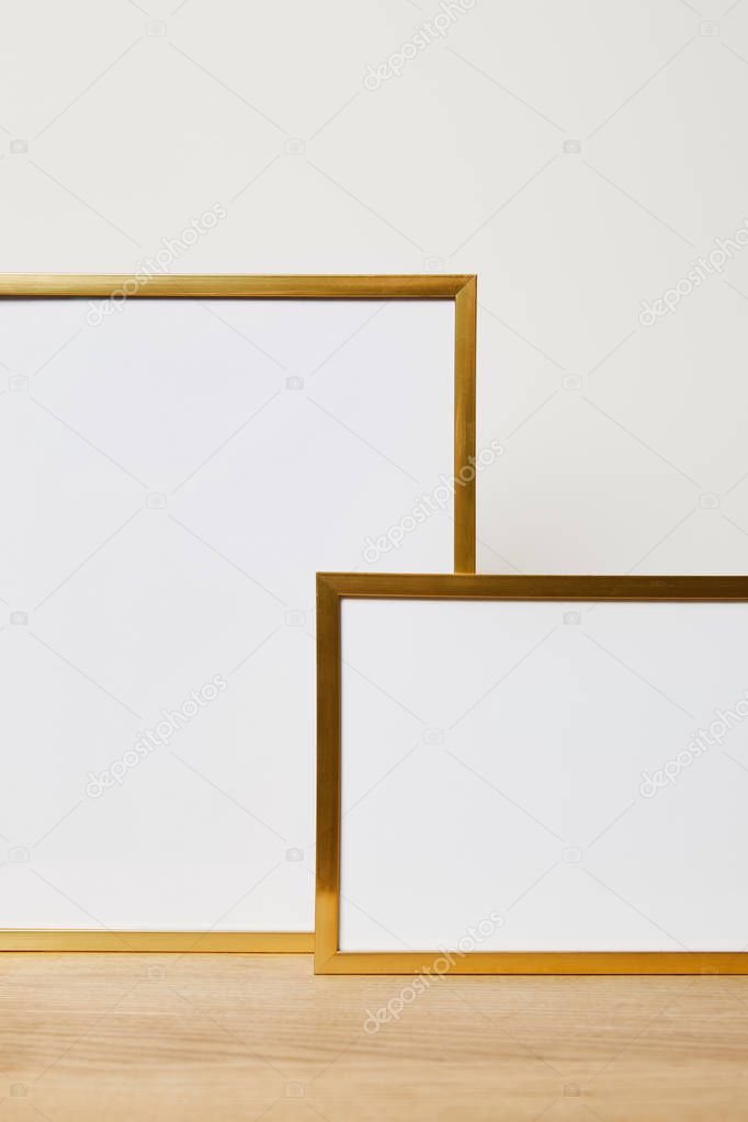 decorative blank frames on wooden table at home