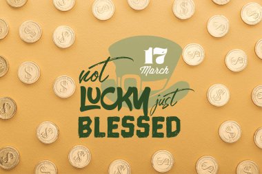 top view of shiny golden coins near not lucky just blessed lettering on orange background clipart