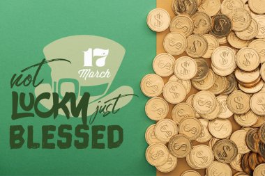 top view of golden coins near not lucky just blessed lettering on green background clipart