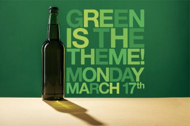 glass beer bottle near green is the theme lettering on green background clipart