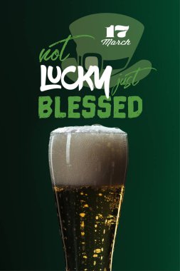 beer glass with foam near not lucky just blessed lettering on green background clipart