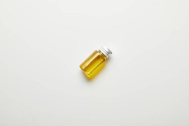 Top view of bottle with essential oil on white background clipart