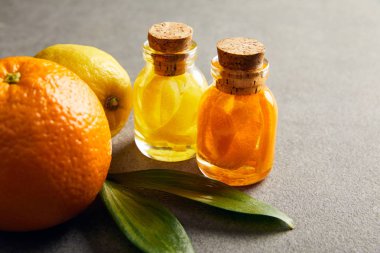 Cam şişe portakal ve limon karanlık yüzeyi ile uçucu yağ