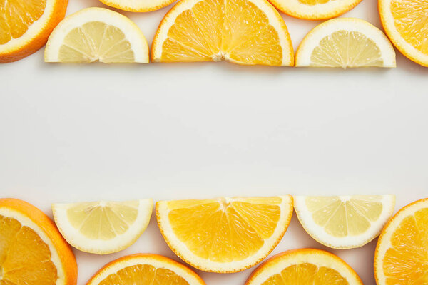Flat lay with orange and lemon slices on white background