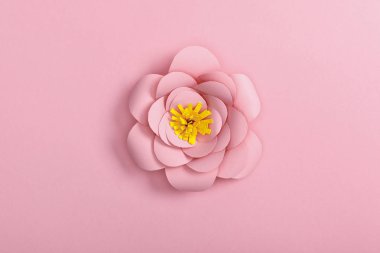 top view of paper flower on pink background clipart