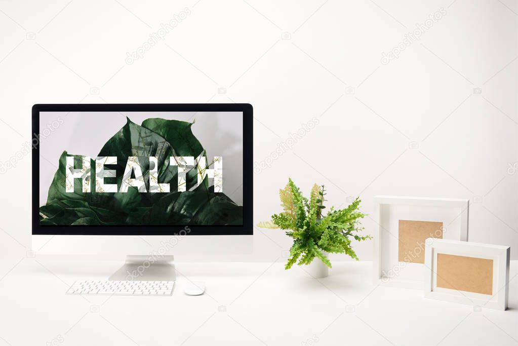 computer with health lettering on monitor on white background