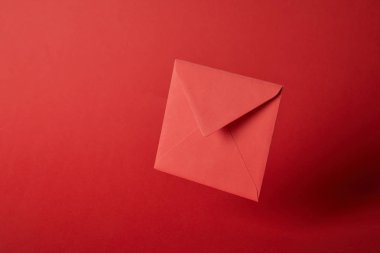 bright, colorful and empty envelope on red background with copy space  clipart
