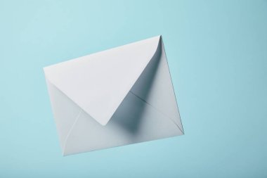 white and blank envelope on blue background with copy space  clipart