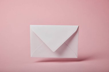 white and empty envelope on pink background with copy space  clipart