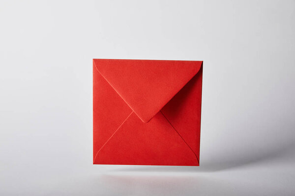 red and colorful envelope on grey background with copy space 