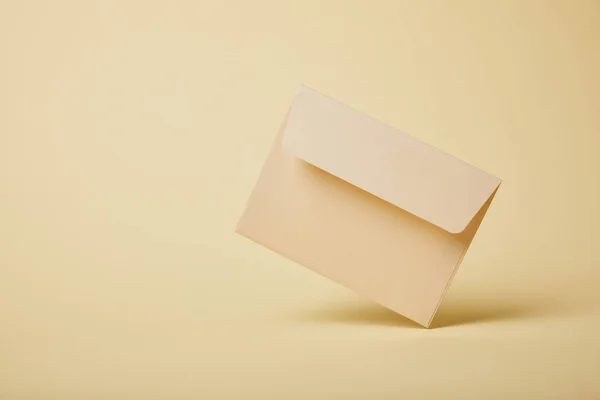 Beige Pastel Envelope Yellow Background Copy Space — Stock Photo, Image