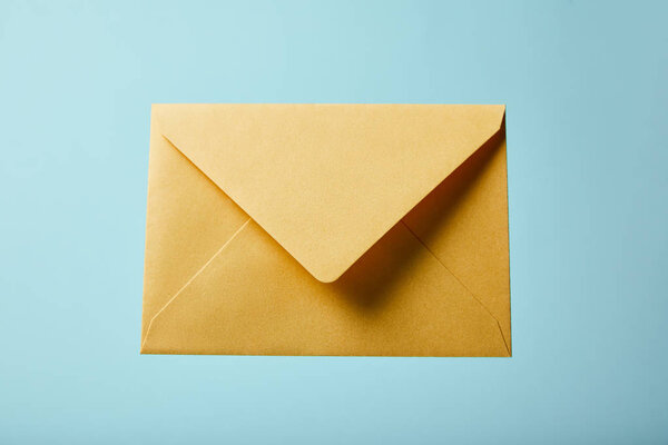 yellow and colorful envelope on blue background with copy space