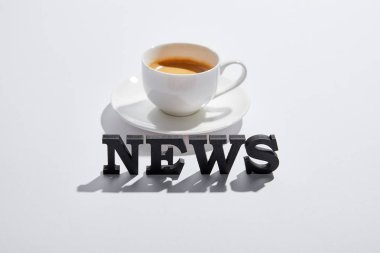 siyah haber yazı ile beyaz kahve fincan yakınındaki 