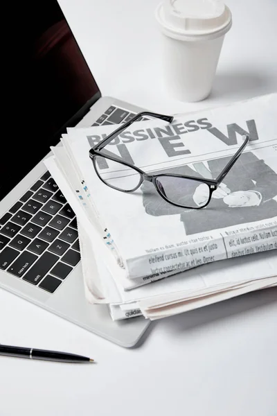 Laptop Blank Screen Business Newspapers Glasses Pen Paper Cup White — Stock Photo, Image