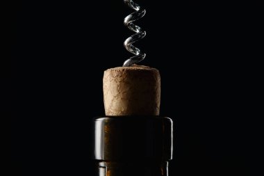 Close up view of bottle with wooden cork and corkscrew isolated on black clipart