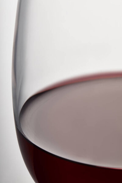 Burgundy red wine in wine glass on white