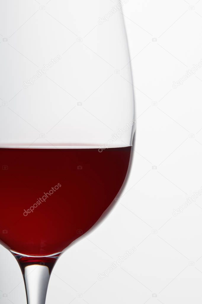 Wine glass with burgundy red wine isolated on white
