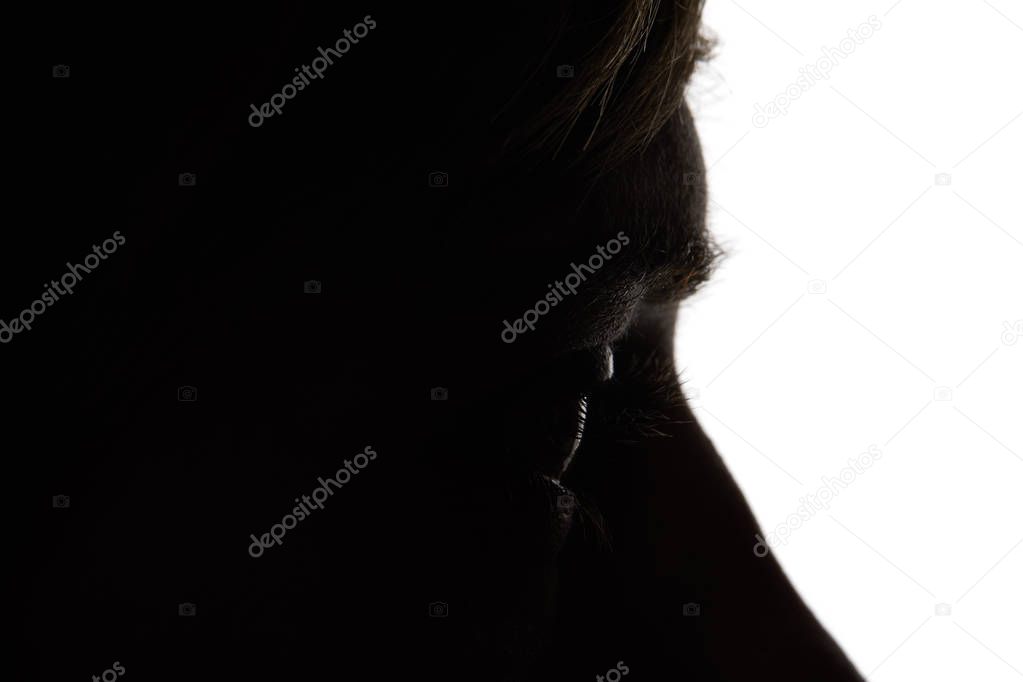 Close up view of woman looking away in darkness on white