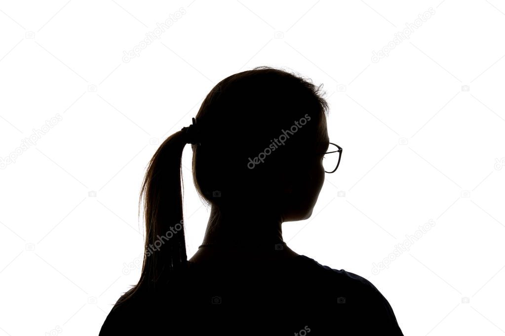 Silhouette of girl in glasses with ponytail looking away isolated on white